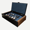 Open AUBLIQ black and brown 10-slot watch box with ten watches, blue lining and a covered strap compartment.