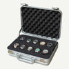 Open silver aluminium 10-slot watch box holding ten watches in black foam, with a padded lid and carry handle.