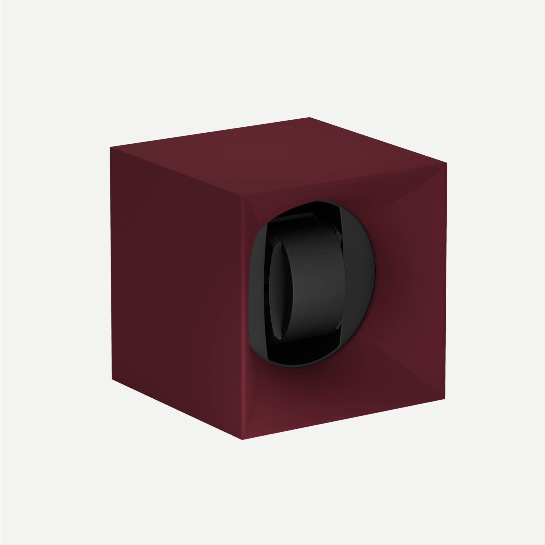 Maroon watch winder with a black watch inside on a white background