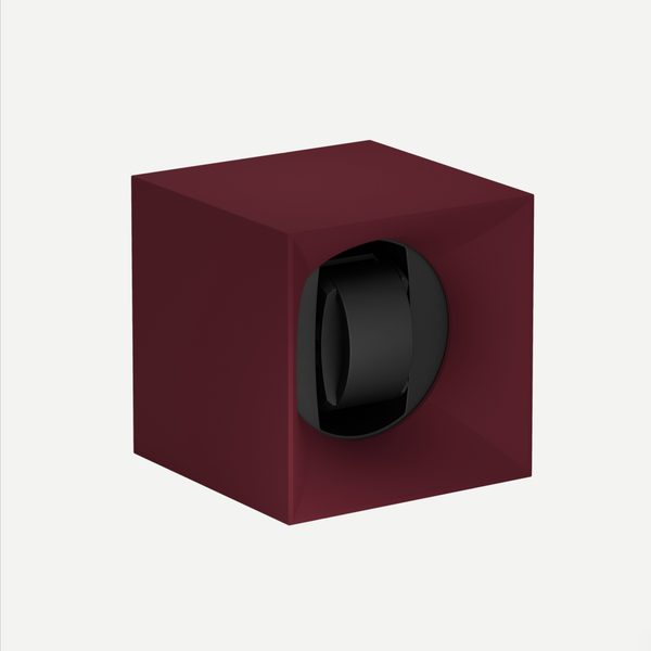 Maroon watch winder with a black watch inside on a white background